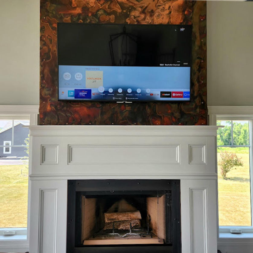 TV mounted above fireplace in Milwaukee WI by Handy Dandy Tech
